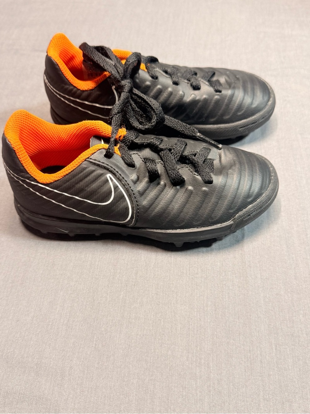 Nike Kids Black Cleats with Bright Orange Lining